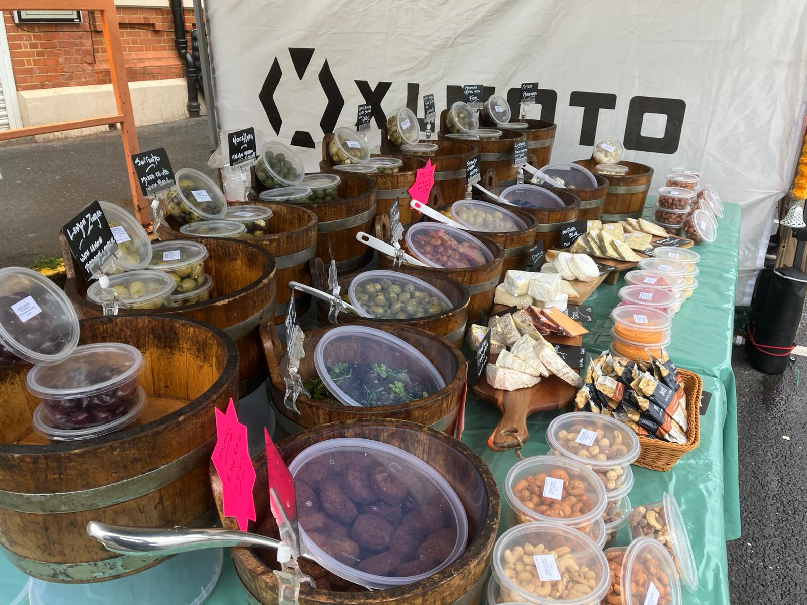 Dave's Olives market stall with customers browsing