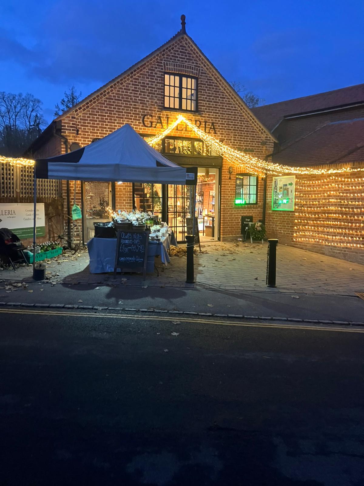 Close-up of wooden buckets filled with varieties of olives and cheeses