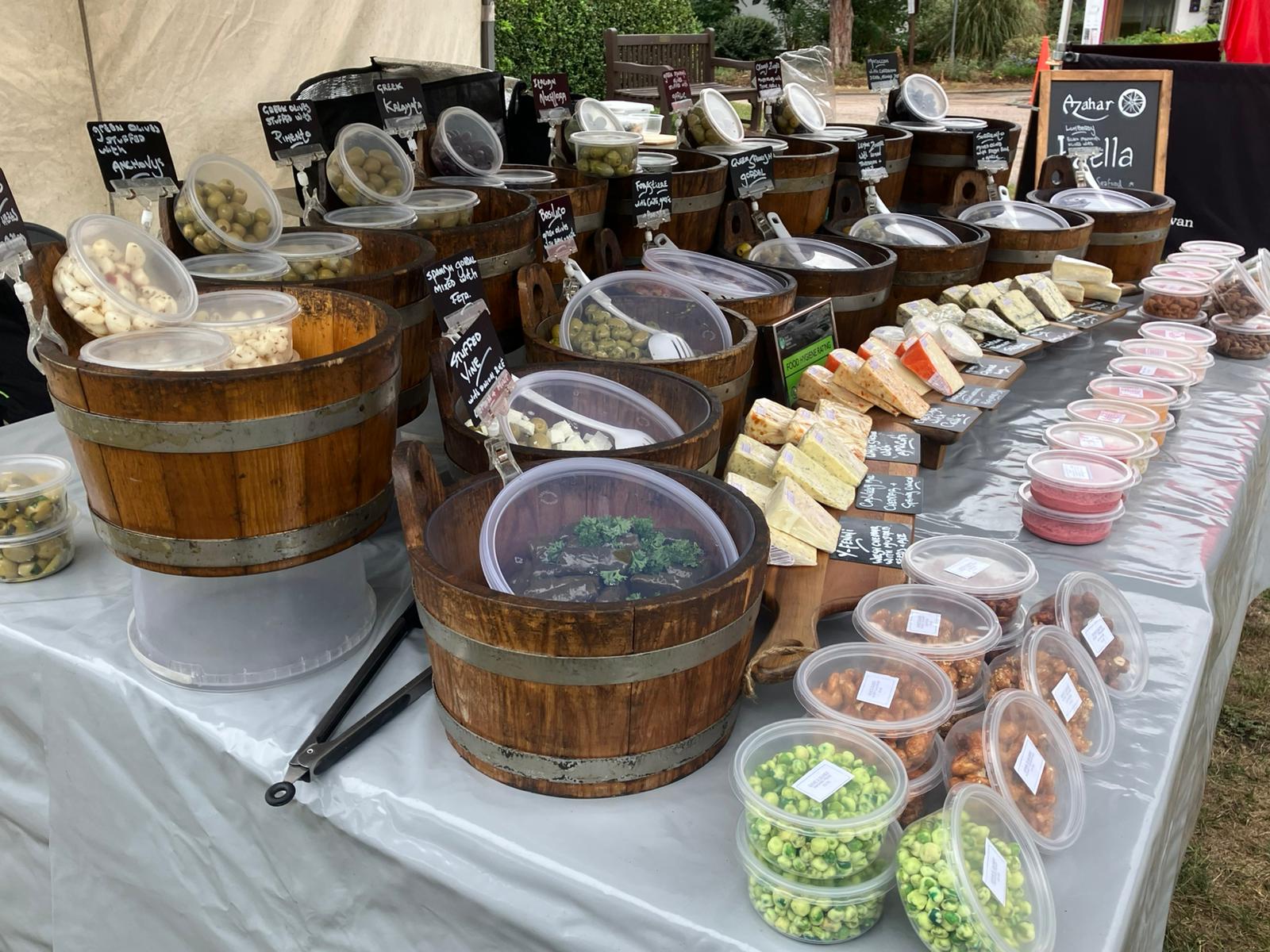 Dave's Olives stall outside the Galleria in the evening with fairy lights
